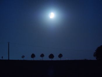 Silhouette landscape against clear sky at night