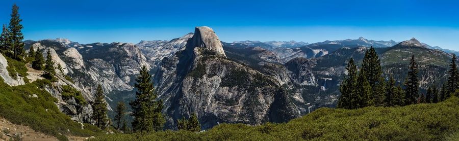 Scenic view of mountains against clear blue sky