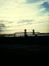 Bridge over sea at sunset