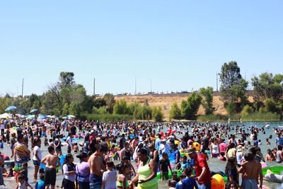 Crowd at music concert against sky