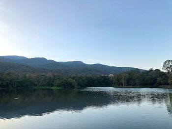 Scenic view of lake by mountains against clear sky