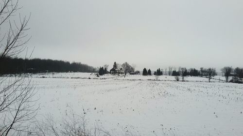 Scenic view of snowy field against clear sky