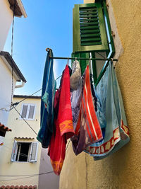 Low angle view of clothes drying outside building