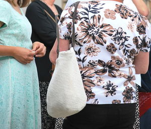 Midsection of couple standing outdoors
