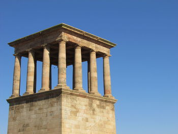 Low angle view of historical building against blue sky