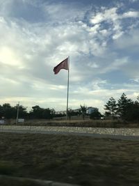 Flag on field against sky