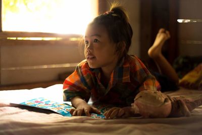 Girl playing on bed