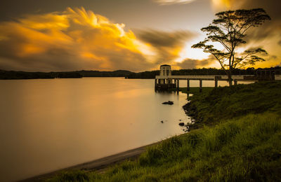 Scenic view of river against sky during sunset