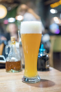 Close-up of beer glass on table