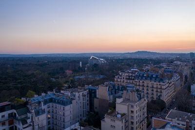High angle view of buildings in city at sunset