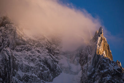 Panoramic view of snowcapped mountains against sky