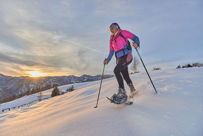 Man standing in snow against sky