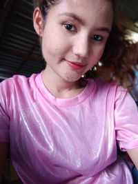 Low angle portrait of smiling mature woman wearing pink top