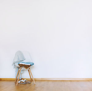 Empty chair against wall at home