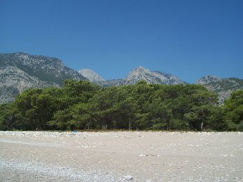 Scenic view of mountains against clear blue sky