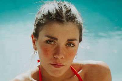 Close-up portrait of a young woman in swimming pool