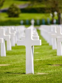 White cross at cemetery during sunny day