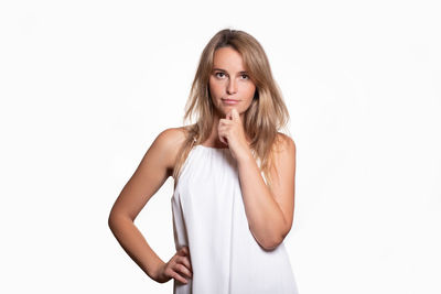 Portrait of woman standing against white background