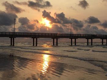 Bridge over river at sunset