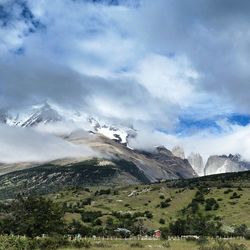 Scenic view of mountains against cloudy sky