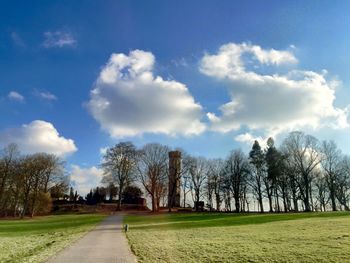 Scenic view of grassy field against cloudy sky