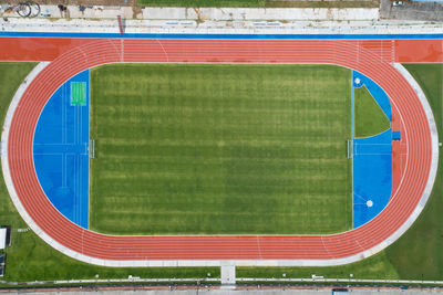 Scenic view of soccer field against blue sky