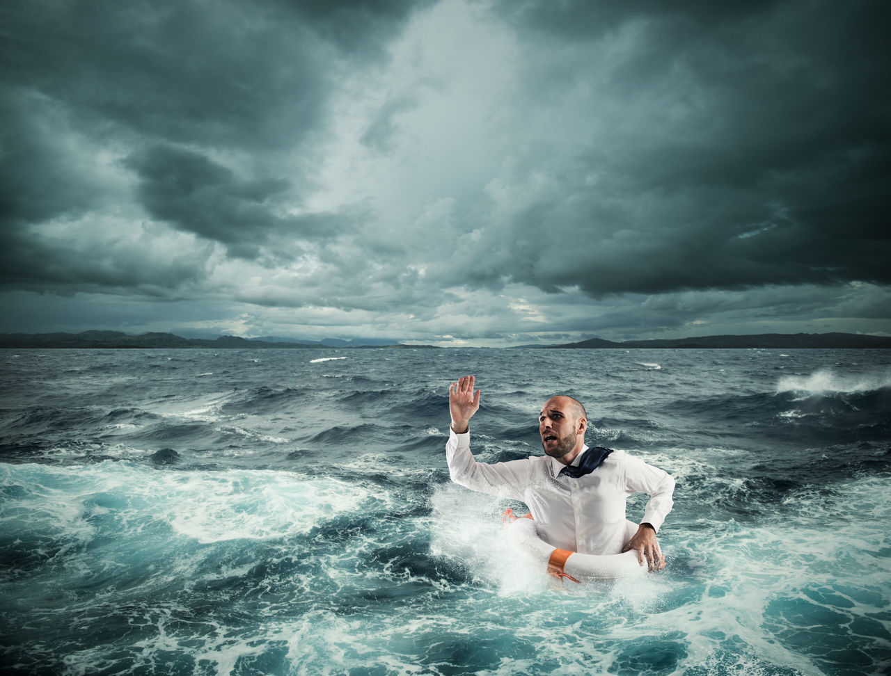 FULL LENGTH OF MAN ON SEA AGAINST SKY