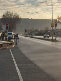 Traffic on road at sunset