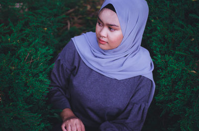 High angle view of young woman in hijab standing on field