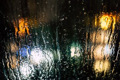 Full frame shot of wet glass window in rainy season