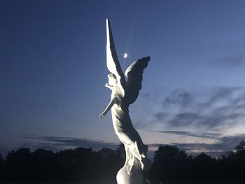 Low angle view of silhouette statue against sky