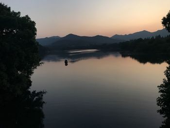 Scenic view of lake against sky during sunset