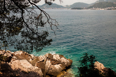 Scenic view of sea and mountains against sky