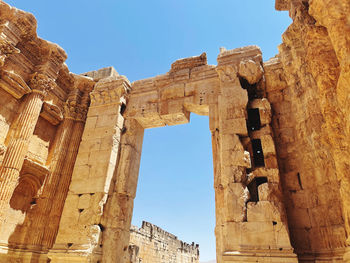 Low angle view of old ruins against clear sky