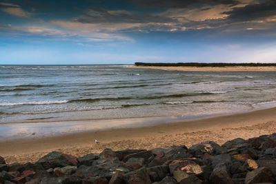 Scenic view of sea against cloudy sky