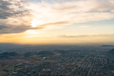 Aerial view of city against sky during sunset