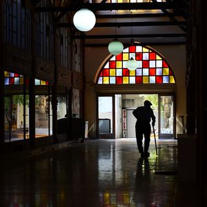 Man walking in corridor of building