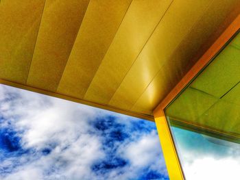 Low angle view of building against cloudy sky
