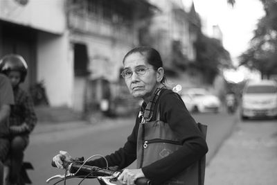 Man with umbrella on street in city