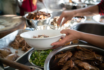 Midsection of person preparing food on table