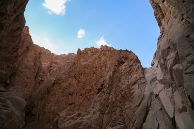 Low angle view of rock formations against sky