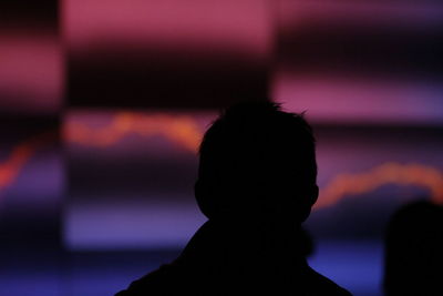 Close-up of silhouette boy against sky during sunset