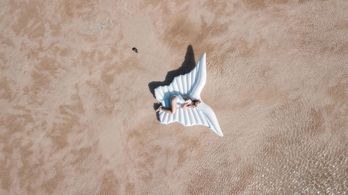 High angle view of young woman lying on floor