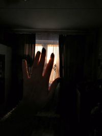 Close-up of hand touching window