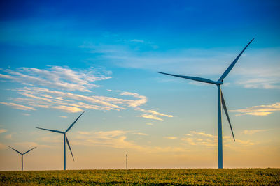 Windmill on field against sky