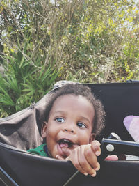 Portrait of young boy sitting in wagon