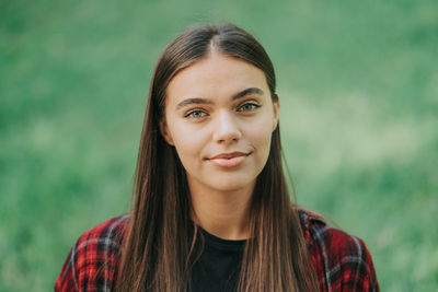Portrait of smiling young woman at park