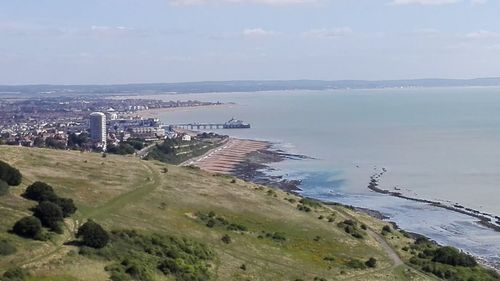 Scenic view of sea and cityscape against sky