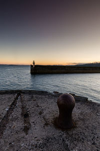 Scenic view of sea against clear sky during sunset