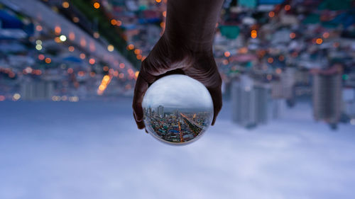 Low section of person on illuminated city